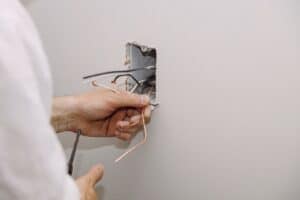 Emergency electrician in kelowna working on power outlet